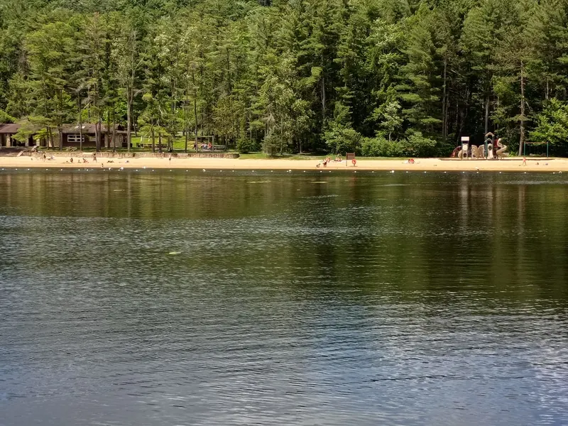 Halfway Lake facing the sand beach, beach house and woodland at R.B. Winter State Park
