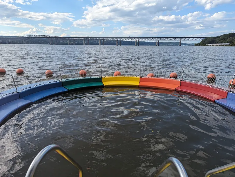 Rainbow rails around the empty floating River Pool at Beacon on the Hudson