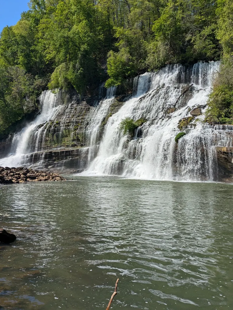 Twin Falls flowing over the wooded cliff at Rock Island State Park; swimming and wading here are prohibited