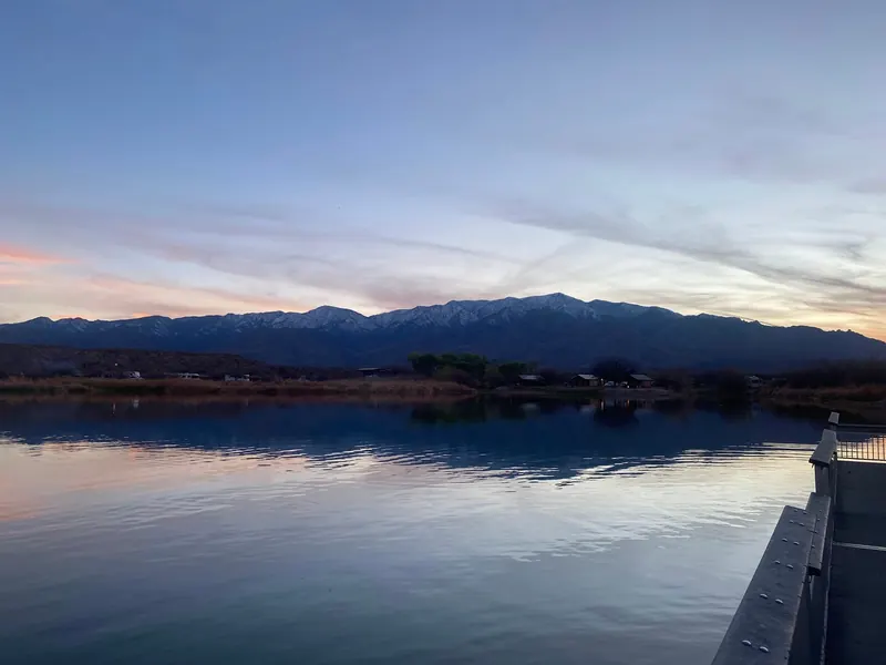 Evening light over Roper Lake with a dock railing in the foreground