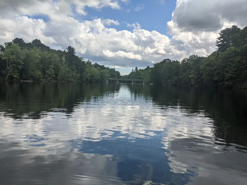 Distant bridge over the wooded Saco River, shown as historical scenery rather than current traffic information