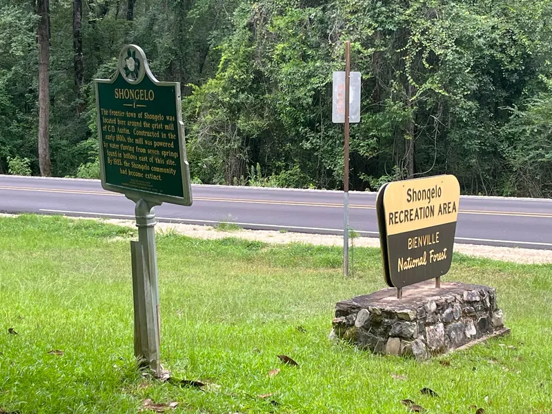 Shongelo historical marker beside the Bienville National Forest recreation-area entrance sign