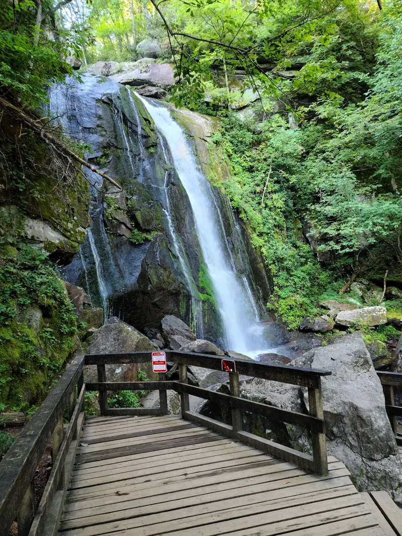Historical waterfall and wooden observation deck with warning signs in the South Mountains State Park collection; falls access is currently closed