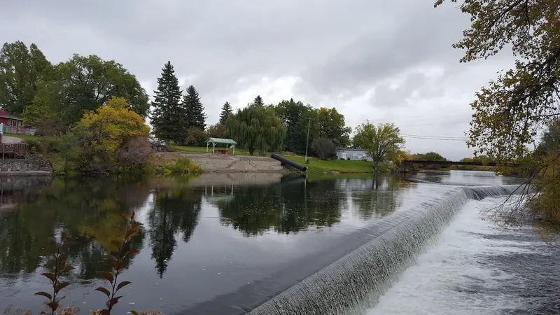 Dam beside the St. Anthony Sand Bar river corridor, shown as hazard context rather than a swimming entry