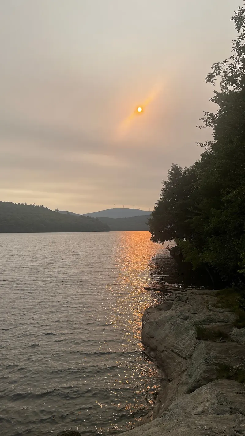 Sunset reflection beside a rocky wooded shore in The Ledges Harriman Reservoir collection