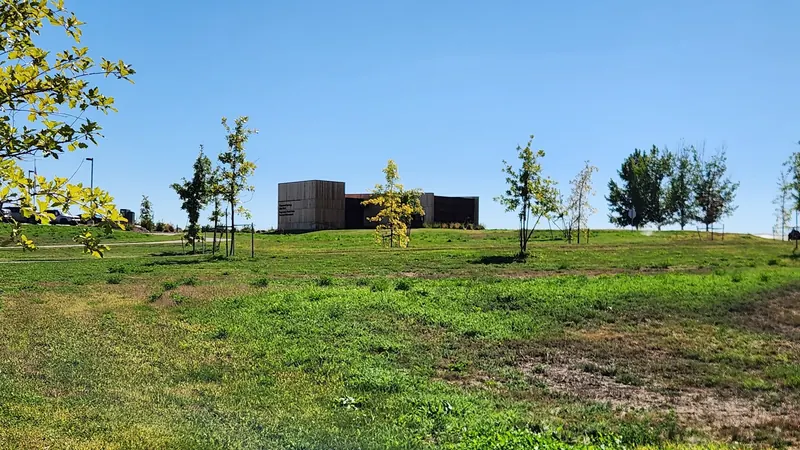 Thousand Springs visitor-center building across a grassy slope in a historical planning-area photograph