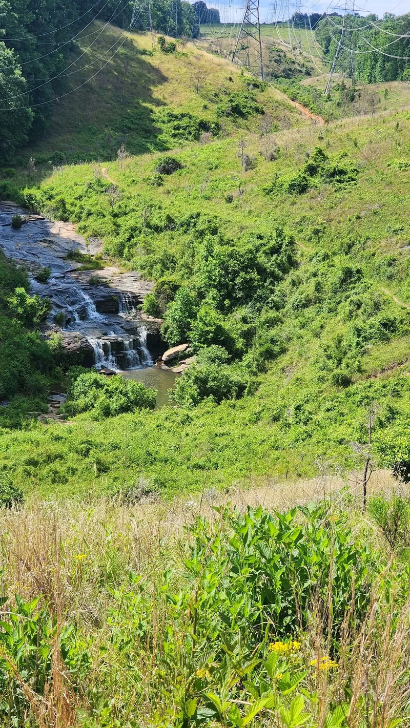 Todd Creek Falls and its surrounding utility corridor landscape