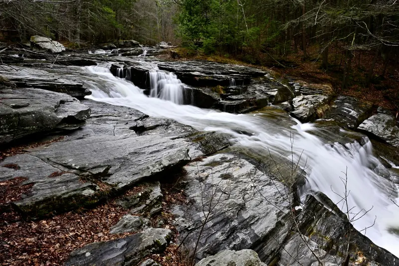 Umpachene Falls cascading over layered rock in a historical photograph