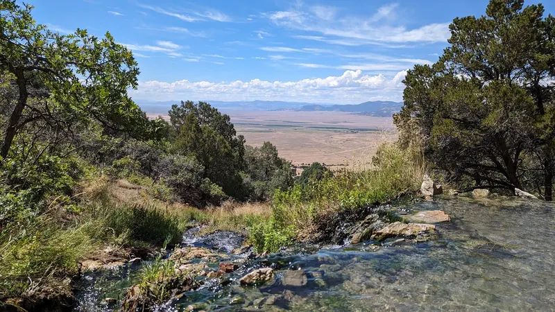 Rock-lined soaking pool overlooking the San Luis Valley at Valley View Hot Springs