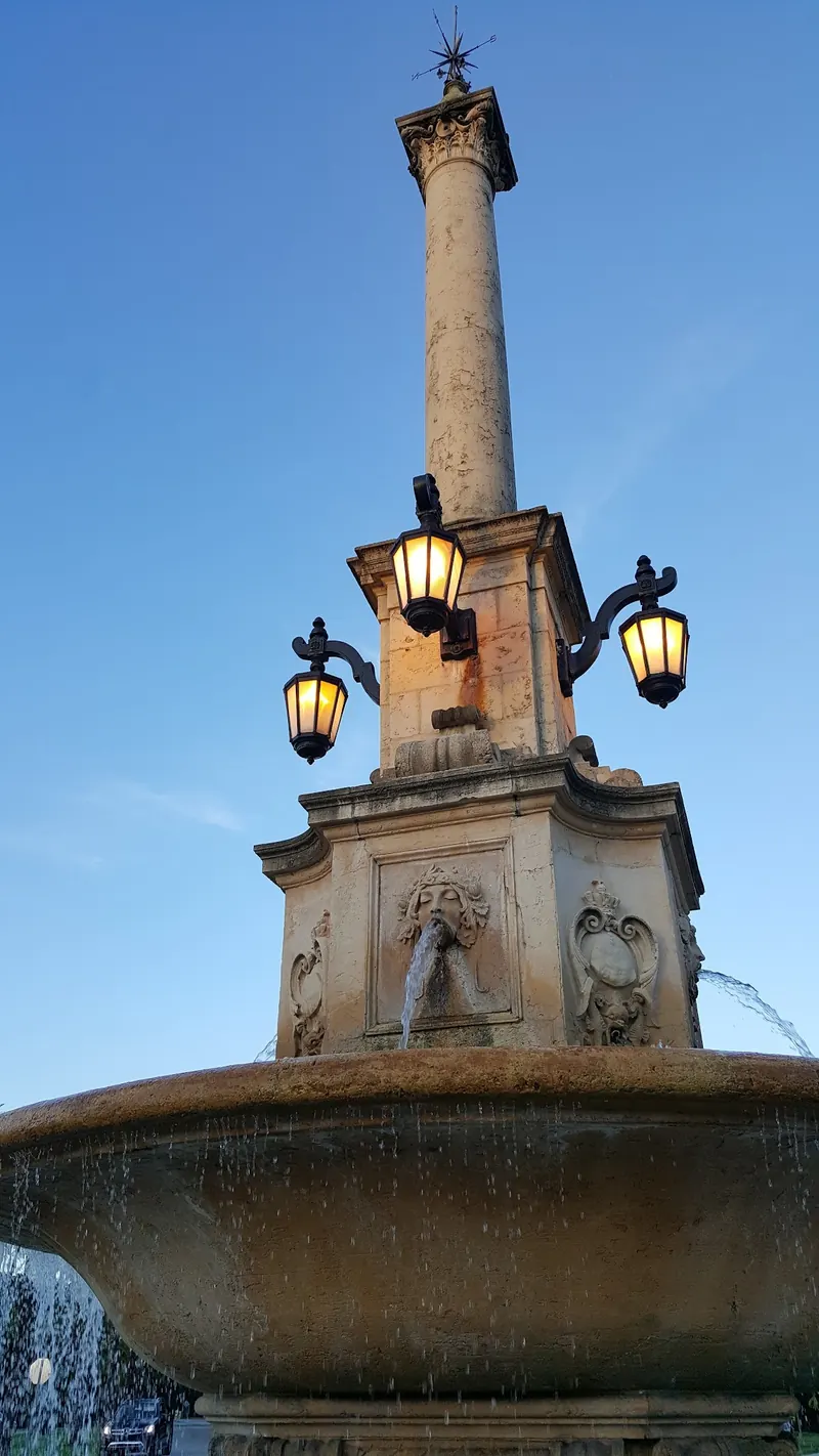 Decorative fountain column and illuminated lanterns near Venetian Pool in Coral Gables; not the swimming pool