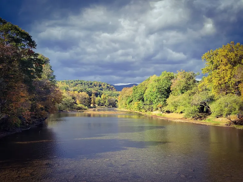River bordered by autumn trees in the Watoga photo collection; regional scenery, not an independently located swimming entry
