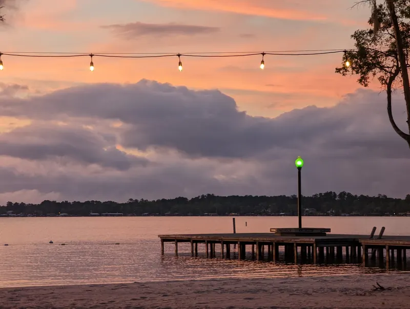 Sunset light over White Lake and an empty shoreline pier