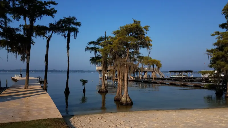 Cypress trees, docks and sandy shoreline along White Lake in North Carolina