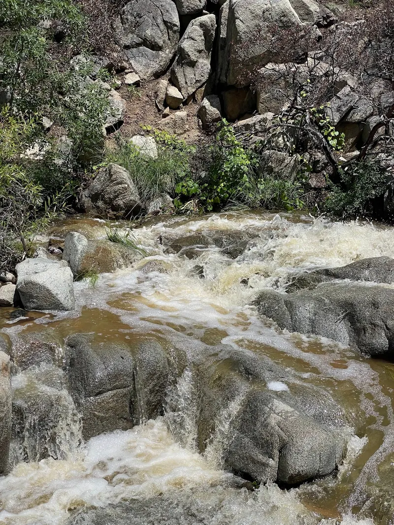 Swift water over granite rocks in the saved Wolf Creek photo set; historical conditions, not pool-depth evidence